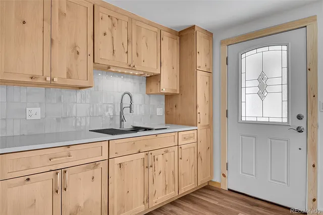 a kitchen with stainless steel appliances granite countertop white cabinets and sink