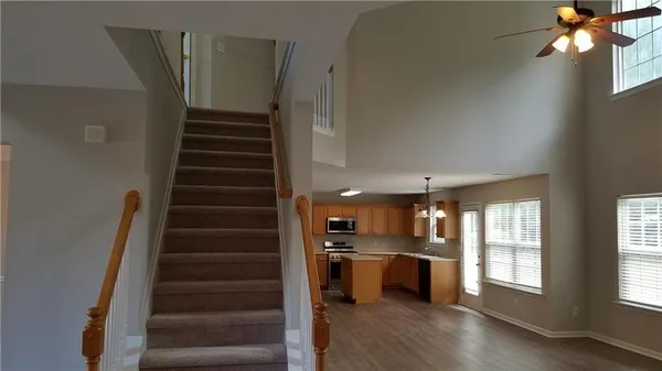 a view of kitchen with sink and refrigerator