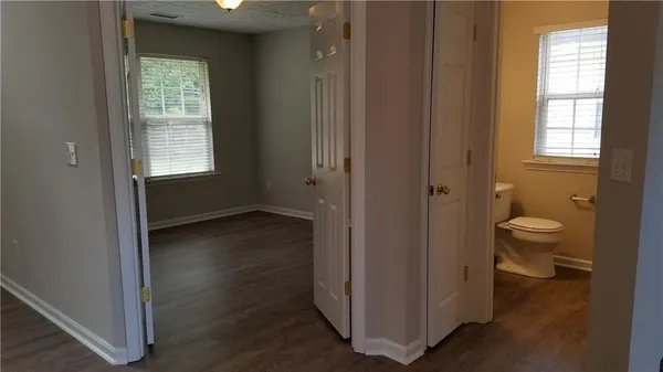 a view of bathroom with a toilet a sink and a window