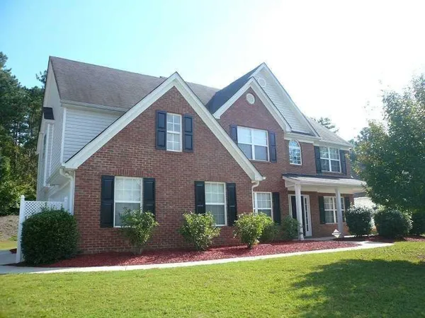 a front view of a house with a yard