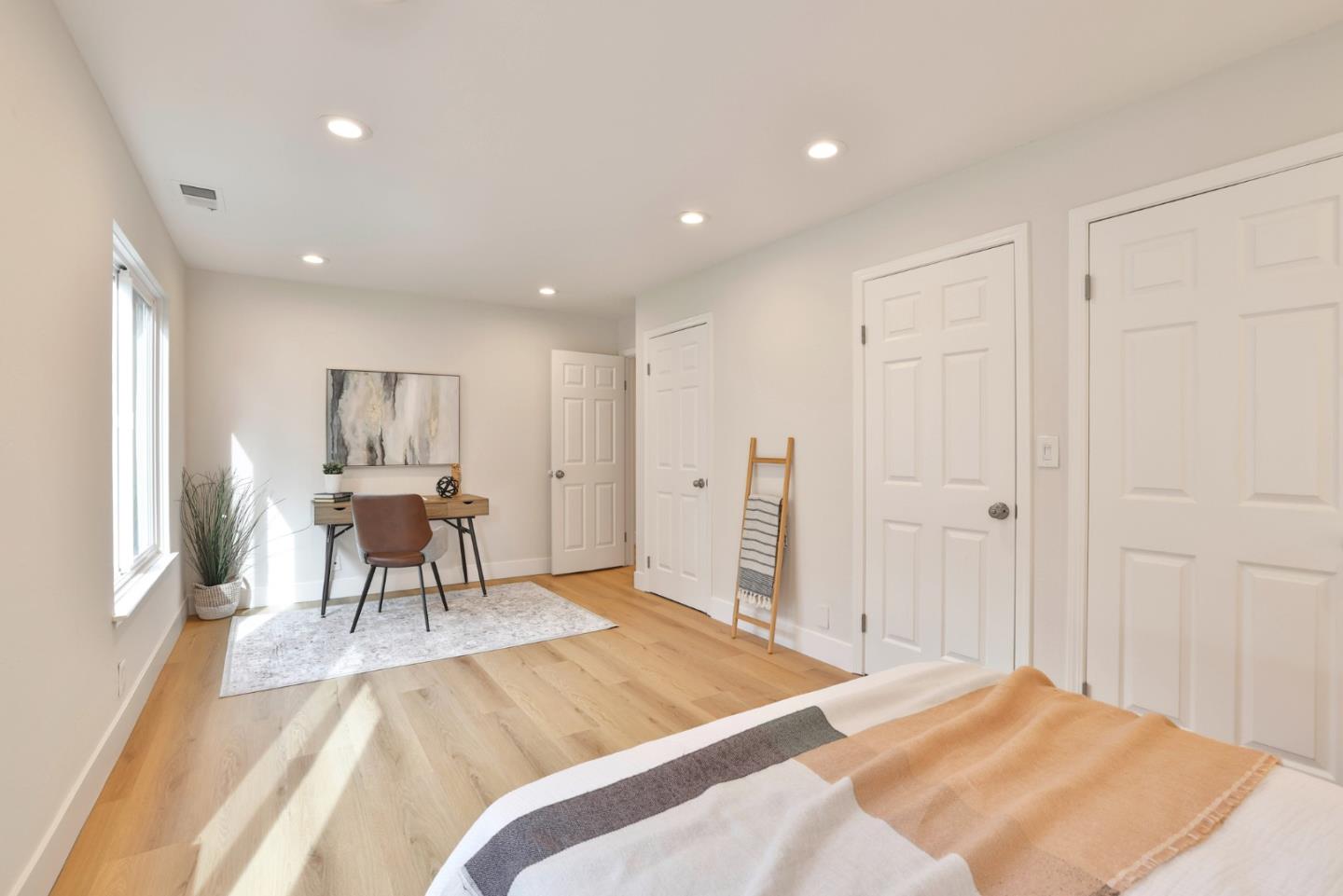 2053 Jonesport Avenue San Jose, CA 95131 - Photo 13 of 28 a spacious bedroom with a bed a table in it and wooden floors