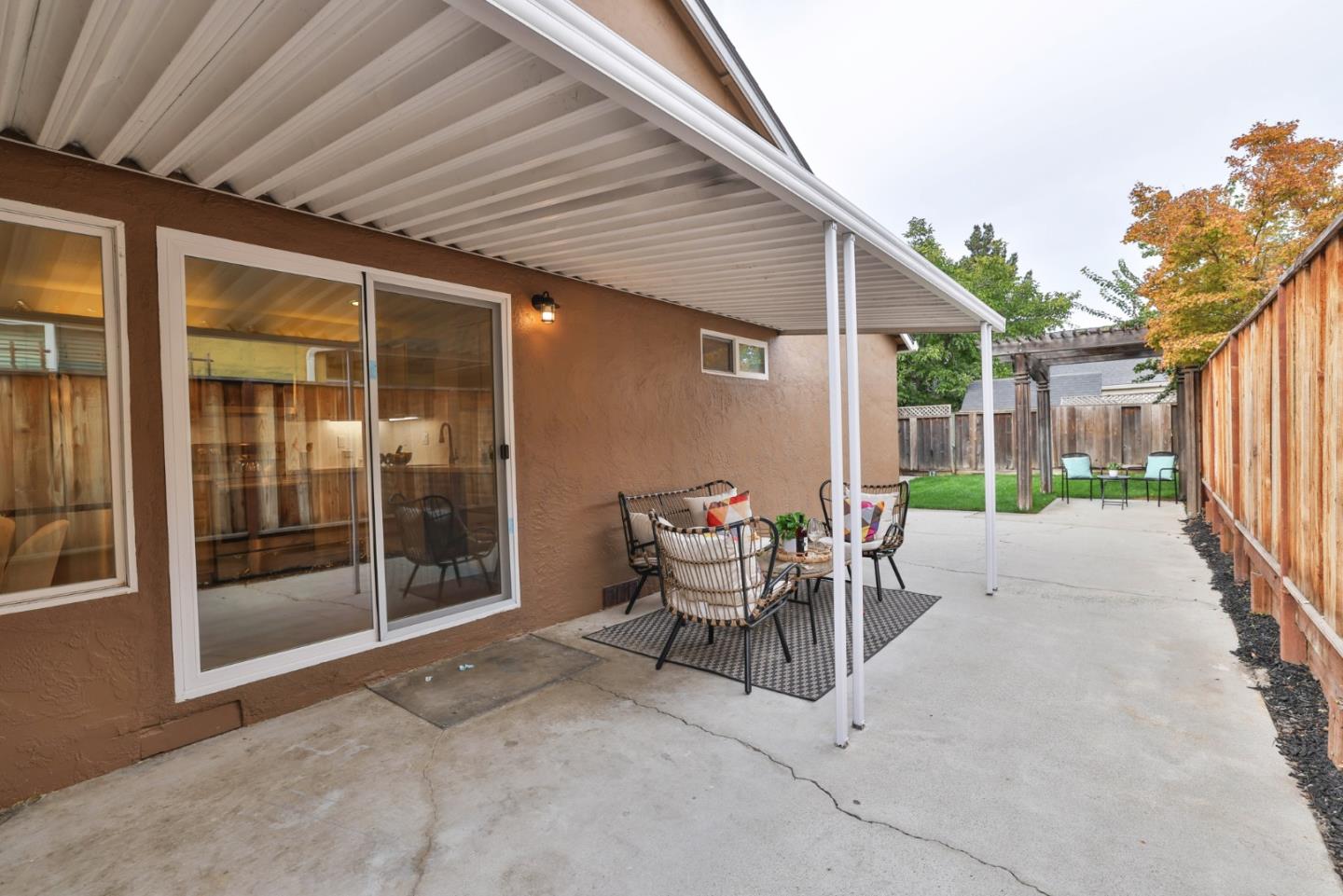 2053 Jonesport Avenue San Jose, CA 95131 - Photo 26 of 28 a view of a patio with table and chairs and floor to ceiling window