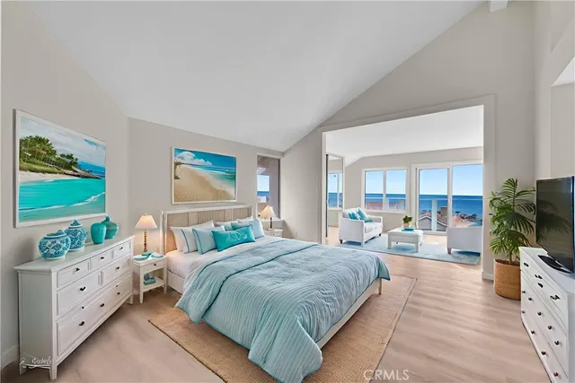 a spacious bedroom with a bed and a flat screen tv