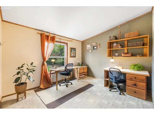 a dining room filled with furniture and a floor to ceiling window