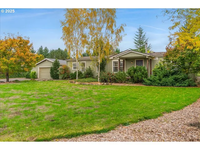 a front view of house with yard and green space