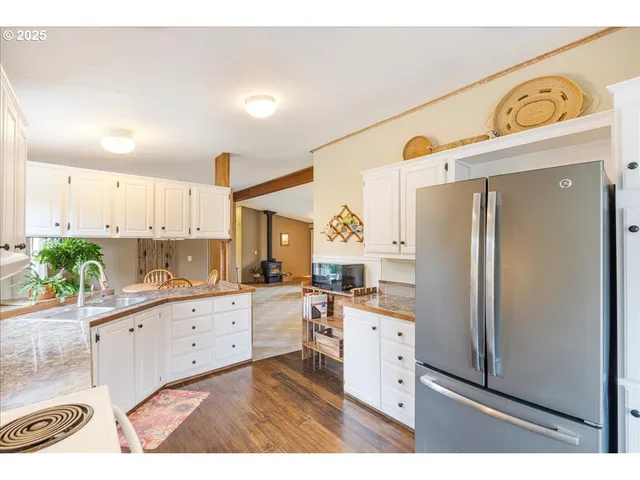 a kitchen with stainless steel appliances granite countertop a refrigerator and a stove top oven