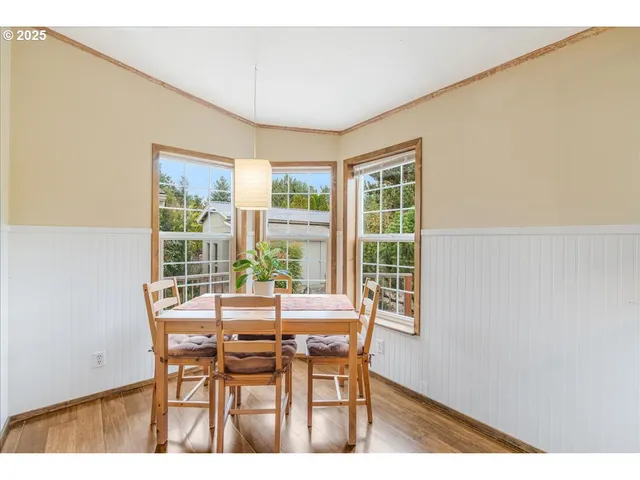 a dining room with a wooden table and chairs