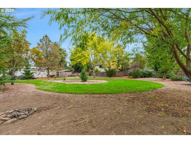 a green field with trees in the background