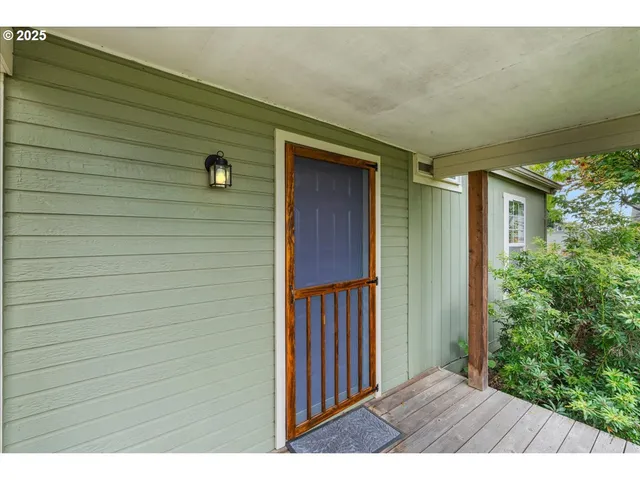 a view of a hallway with wooden floor and a bookshelf