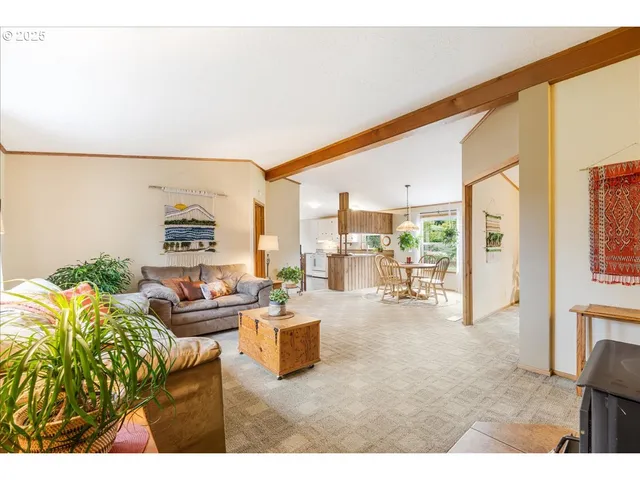 a living room with furniture large window and a table