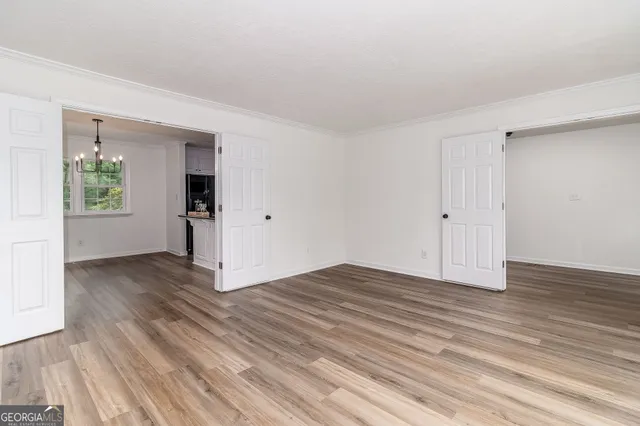 a kitchen with granite countertop white cabinets and sink