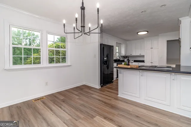 a view of deck with wooden floor and fence next to a yard