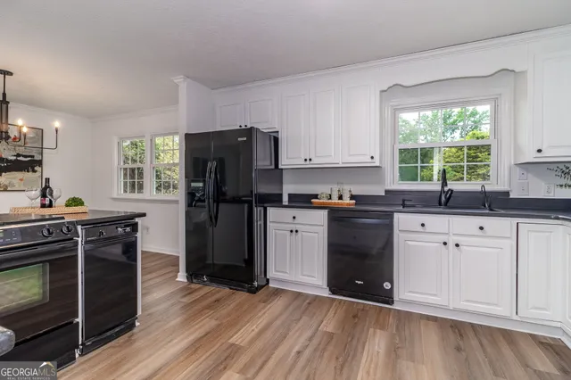 an empty room with wooden floor and ceiling fan