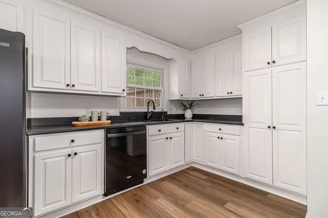 a view of wooden floor and a chandelier fan in a room