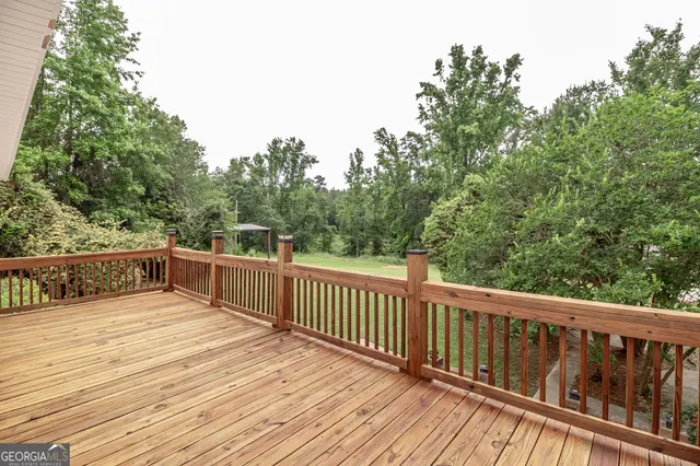 a closeup of a sink with white cabinets