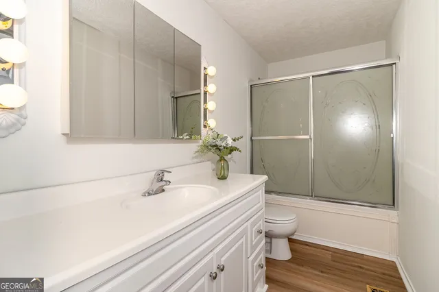 a bathroom with a sink a mirror and a shower