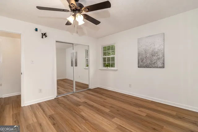 a view of a room with wooden floor and a sink