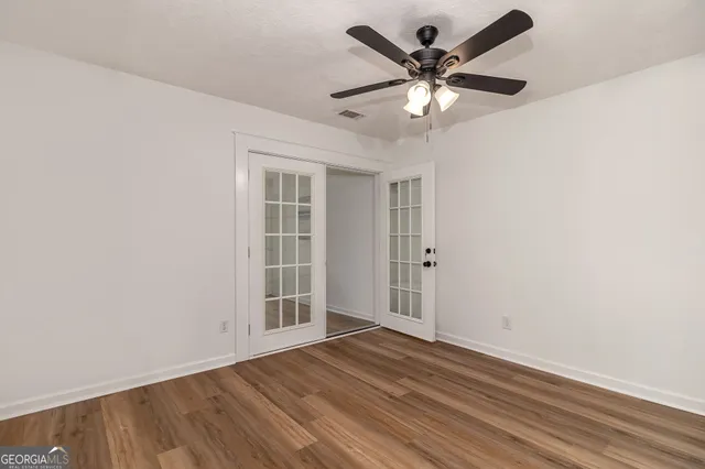 a view of a room with wooden floor and windows