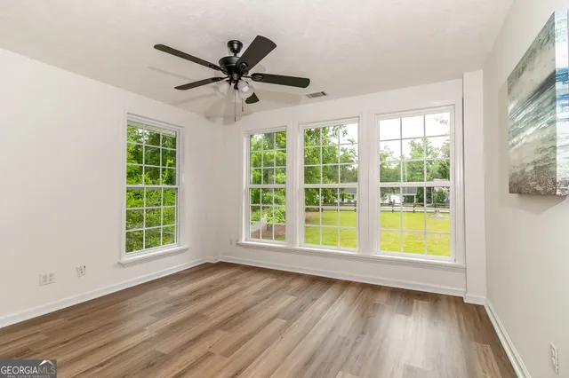 an aerial view of residential house with outdoor space and trees all around