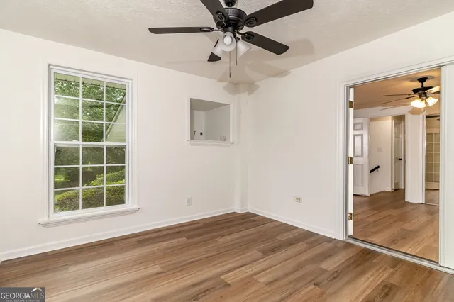 an aerial view of residential houses with outdoor space and trees