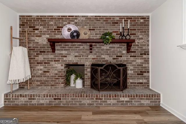 an aerial view of residential house with outdoor space and trees all around