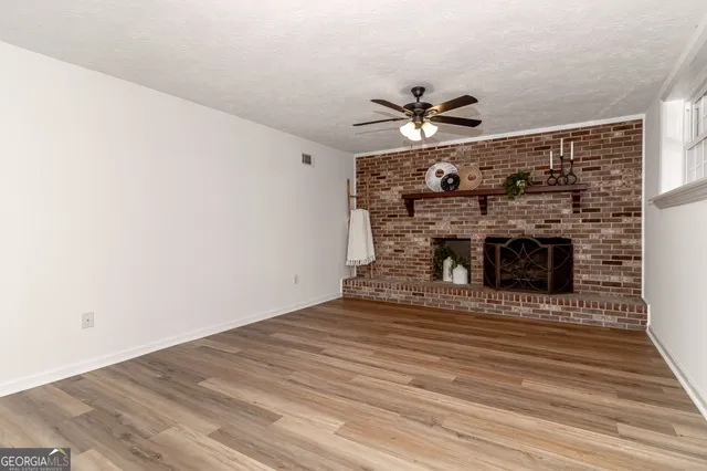an aerial view of a house with a yard and lake view