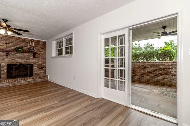 an aerial view of residential house with outdoor space and trees all around