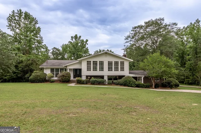 a view of a room with wooden floor and white walls