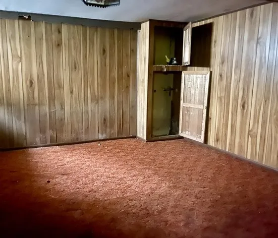 a view of a yard with wooden fence