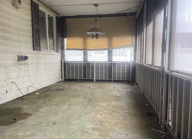 a view of a porch with wooden floor