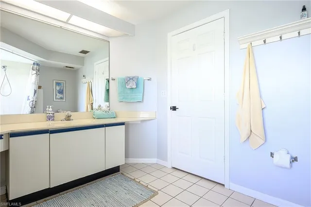 a bedroom with two beds and a window