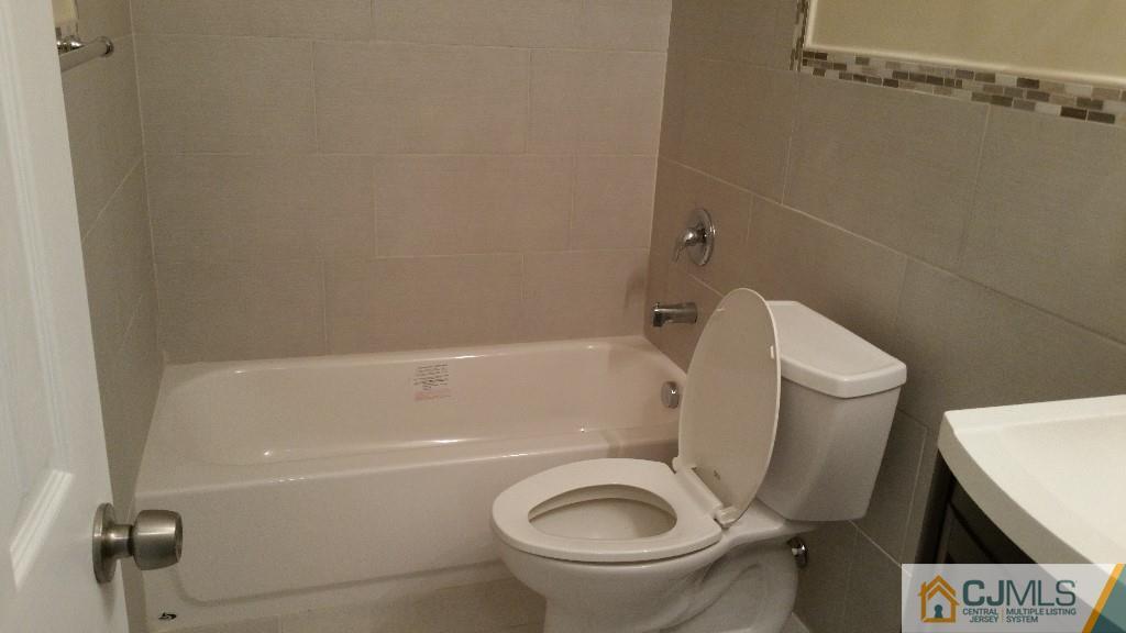 125 Winthrop Road Edison, NJ 08817 - Photo 11 of 23 a white toilet sitting next to a bath tub