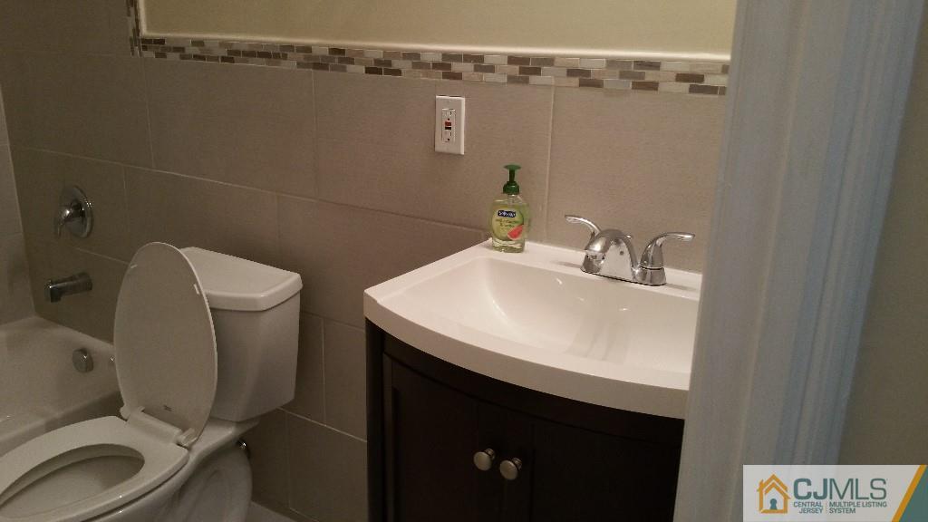 125 Winthrop Road Edison, NJ 08817 - Photo 12 of 23 a bathroom with a sink toilet and a mirror