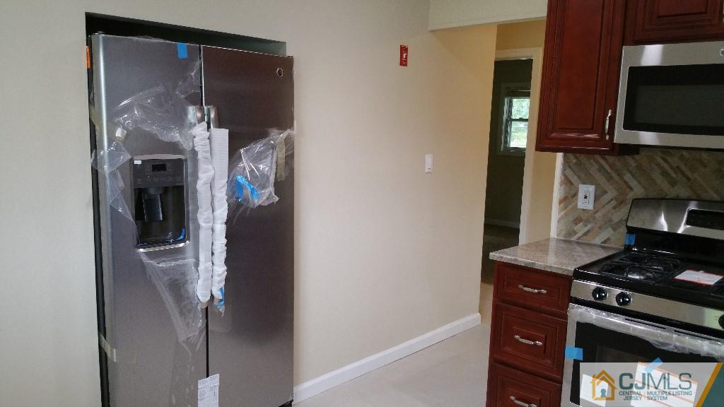 125 Winthrop Road Edison, NJ 08817 - Photo 18 of 23 a kitchen with stainless steel appliances granite countertop a stove and a refrigerator
