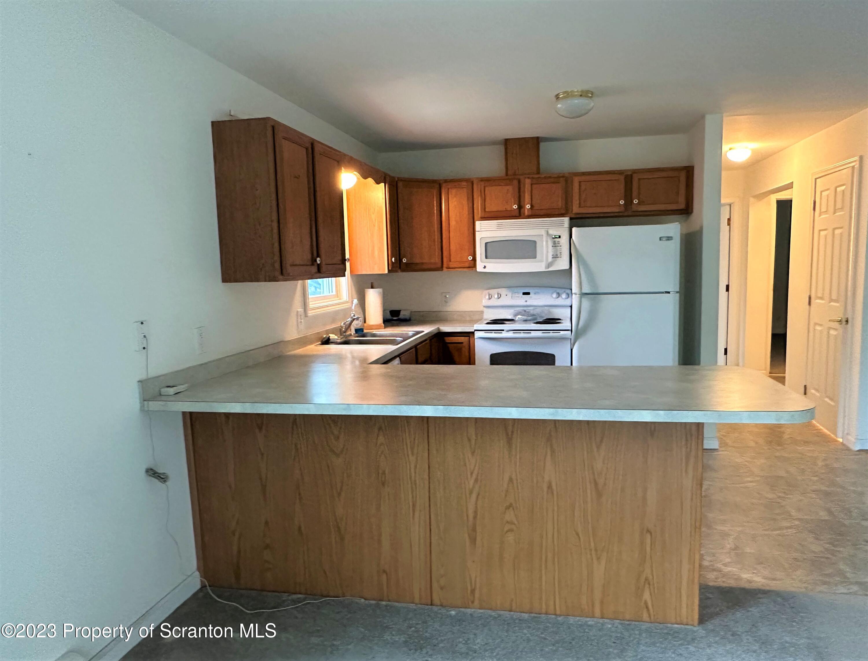 490 Bow Bridge Road Little Meadows, PA 18830 - Photo 4 of 54 a kitchen with stainless steel appliances granite countertop a sink a stove and a refrigerator