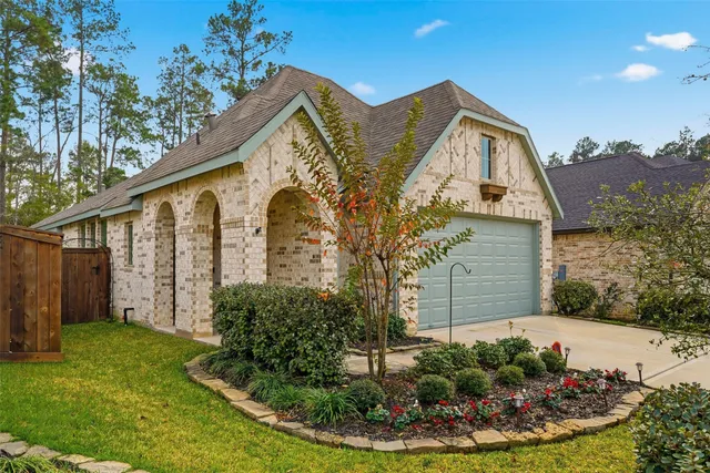 a front view of house with a garden
