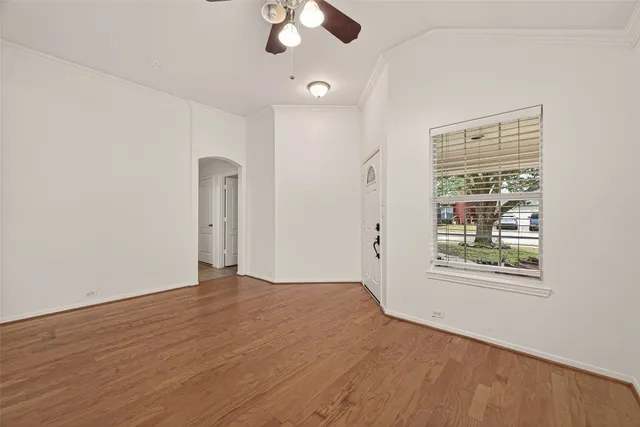 wooden floor in an empty room with a window