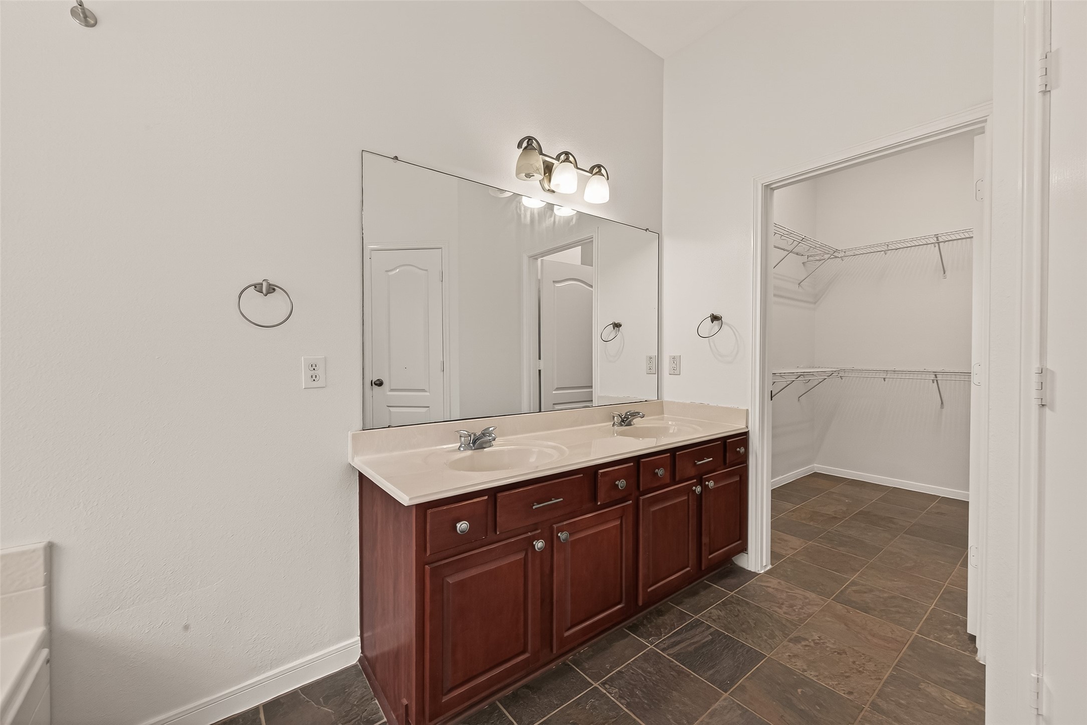 2704 Hewn Rock Way Pearland, TX 77584 - Photo 19 of 40 a spacious bathroom with a granite countertop sink a mirror and a shower