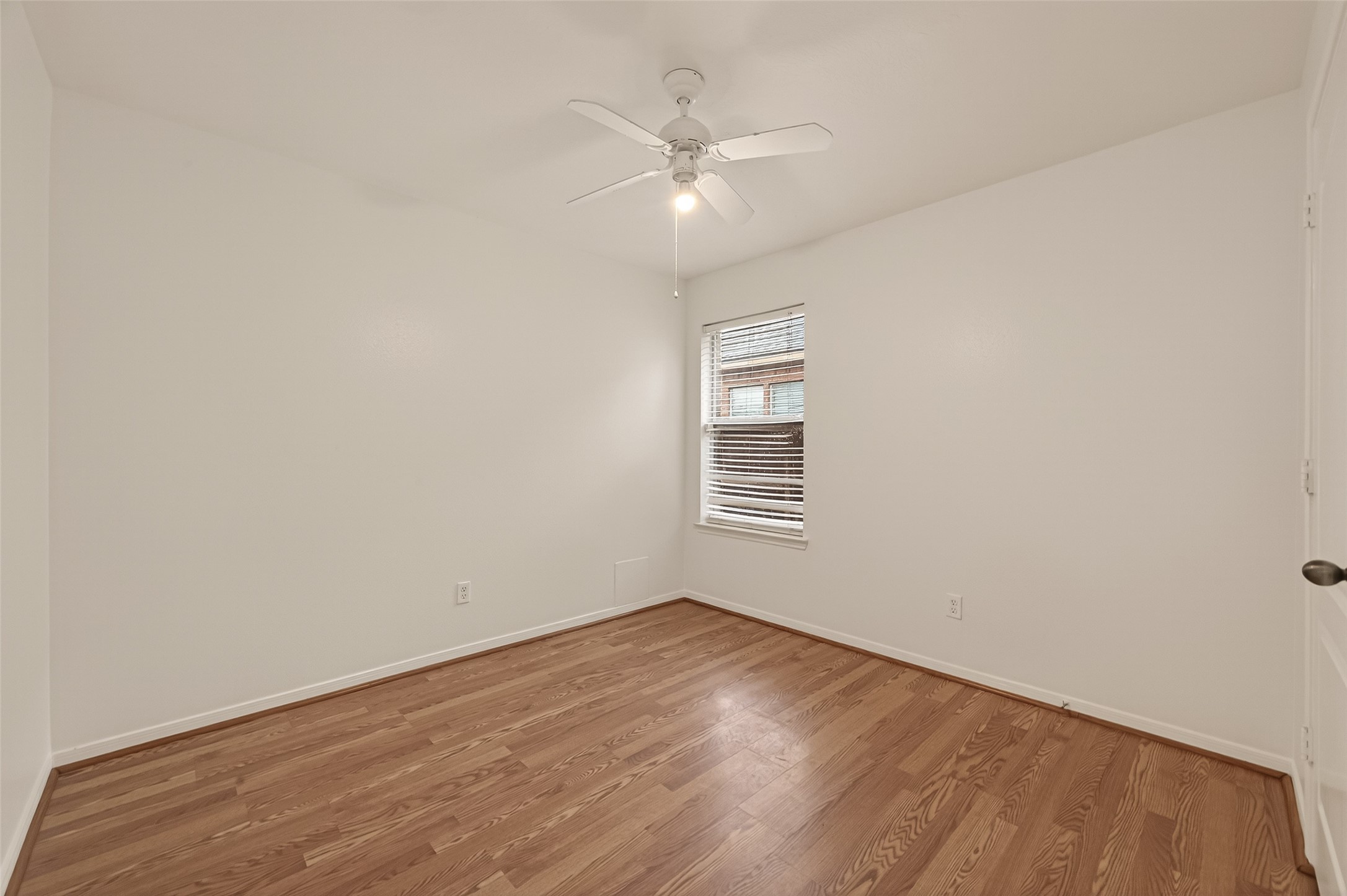 2704 Hewn Rock Way Pearland, TX 77584 - Photo 20 of 40 an empty room with wooden floor and windows