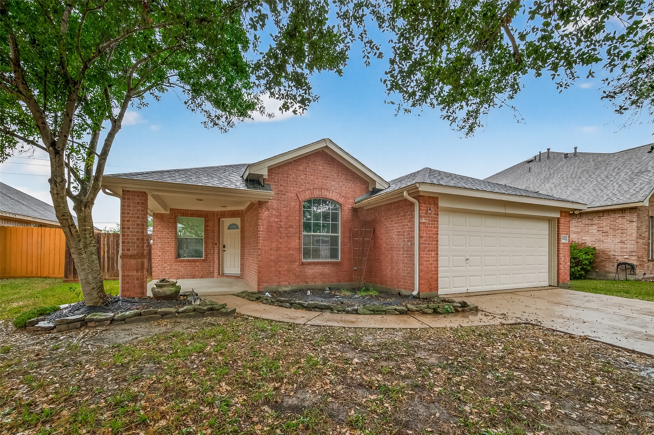 2704 Hewn Rock Way Pearland, TX 77584 - Photo 2 of 40 a front view of a house with a yard and garage
