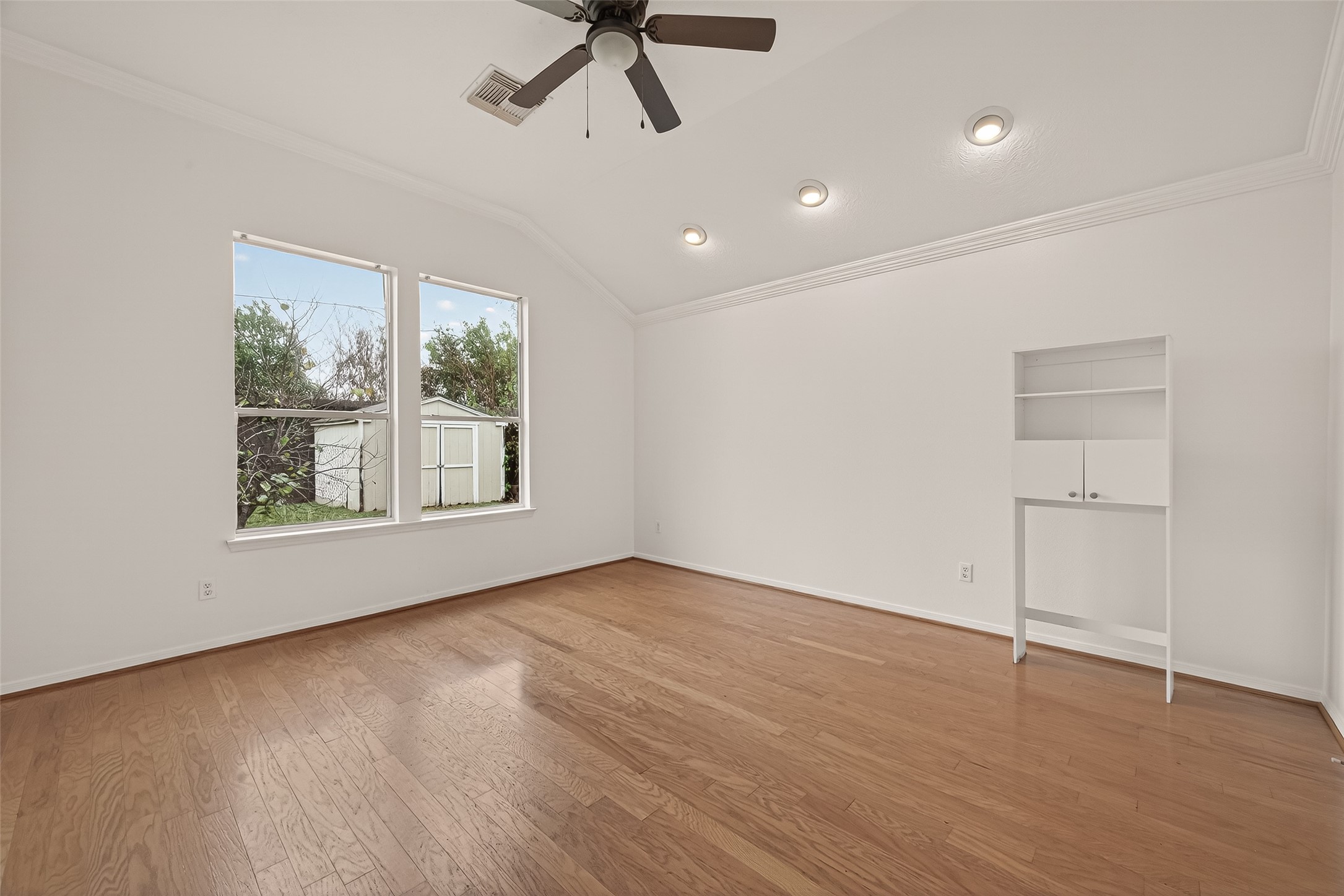 2704 Hewn Rock Way Pearland, TX 77584 - Photo 21 of 40 a view of an empty room with a window and wooden floor