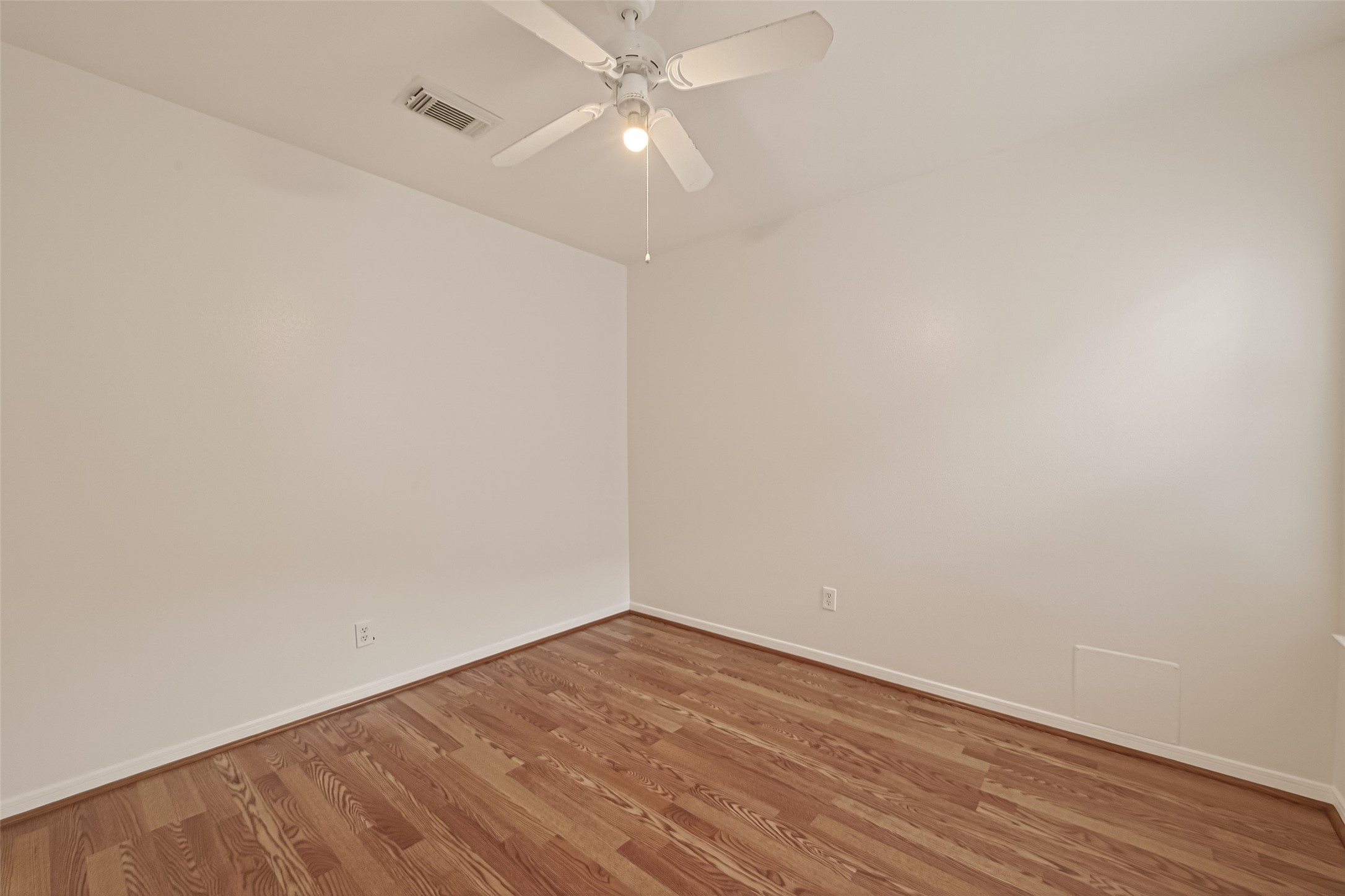 2704 Hewn Rock Way Pearland, TX 77584 - Photo 25 of 40 a view of an empty room with wooden floor