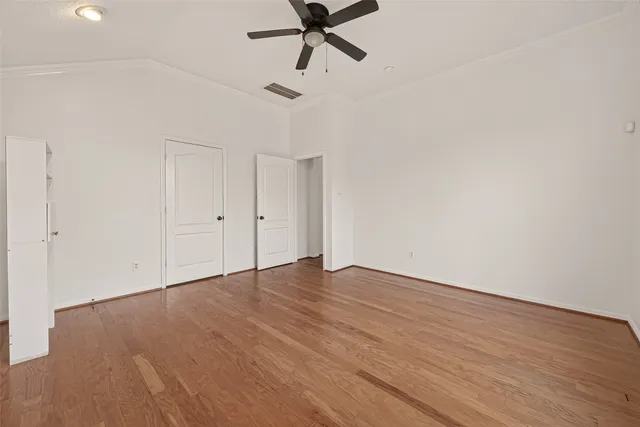a view of an empty room and wooden floor