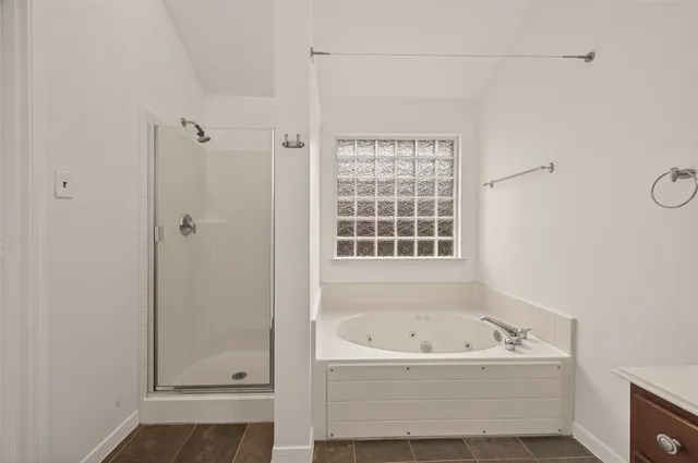 a bathroom with a bathtub and shower