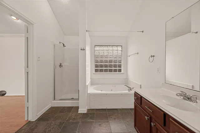 a bathroom with a bathtub sink and mirror