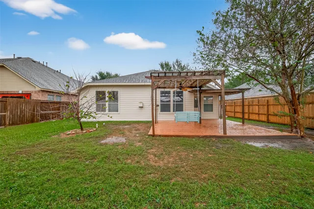 a view of a house with backyard and sitting area