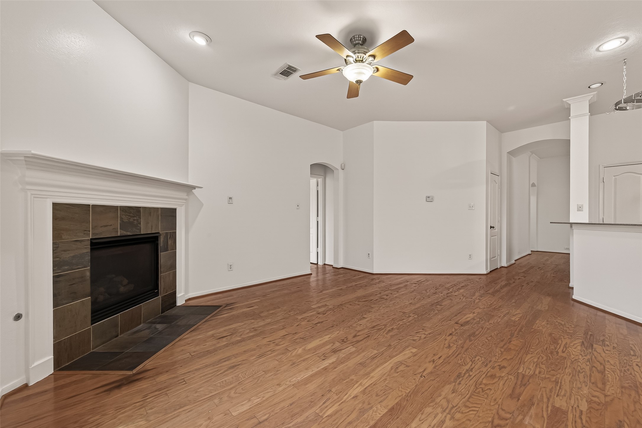2704 Hewn Rock Way Pearland, TX 77584 - Photo 7 of 40 a view of empty room with wooden floor and fireplace