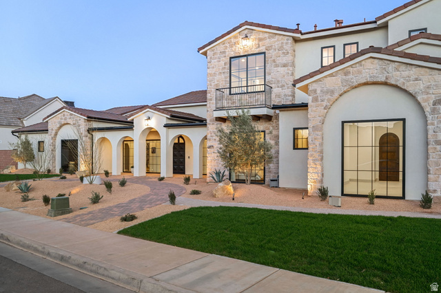 4871 South Homestead Way Washington, UT 84780 - Photo 3 of 151 Mediterranean / spanish-style home featuring stucco siding, stone siding, a balcony, and a front lawn