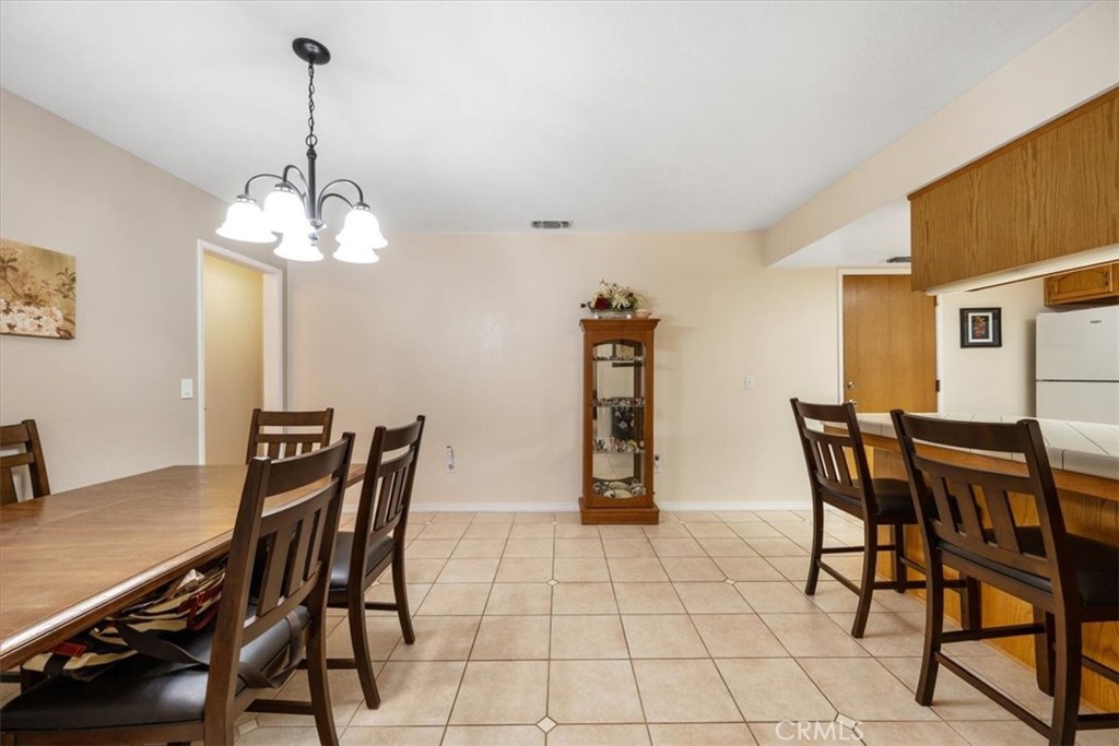 834 Nicklaus Street Paso Robles, CA 93446 - Photo 11 of 37 a view of a dining room with furniture and chandelier