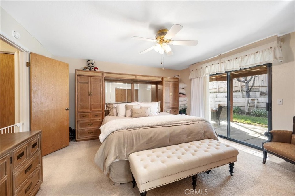 834 Nicklaus Street Paso Robles, CA 93446 - Photo 13 of 37 a bedroom with a large bed and a chandelier